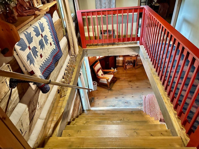 stairs with hardwood / wood-style floors