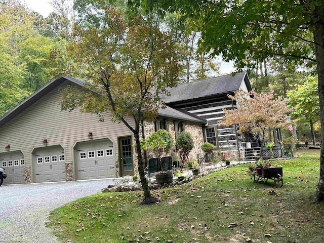 view of side of property featuring a yard and a garage