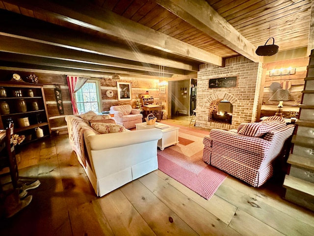 interior space with a fireplace, beamed ceiling, wood ceiling, and hardwood / wood-style flooring