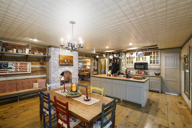 interior space with a brick fireplace, an inviting chandelier, and sink