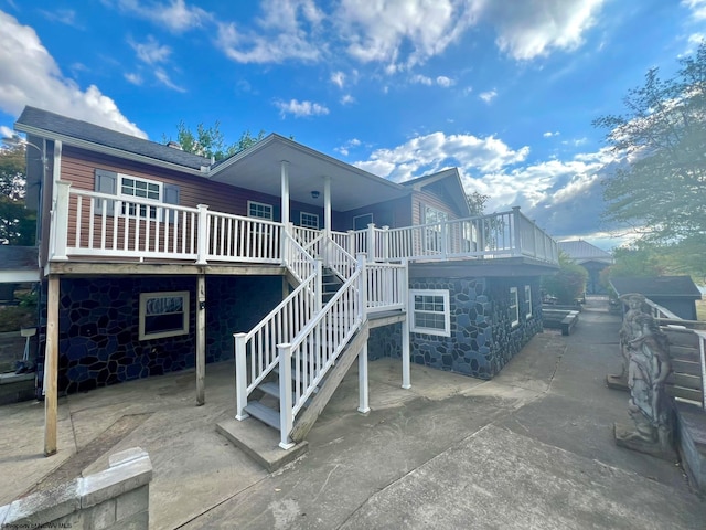 rear view of house featuring a patio area and a deck