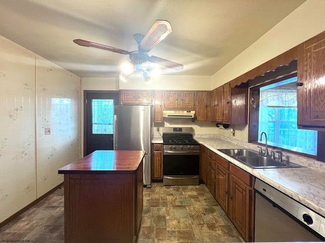 kitchen featuring a kitchen island, a wealth of natural light, sink, and stainless steel appliances