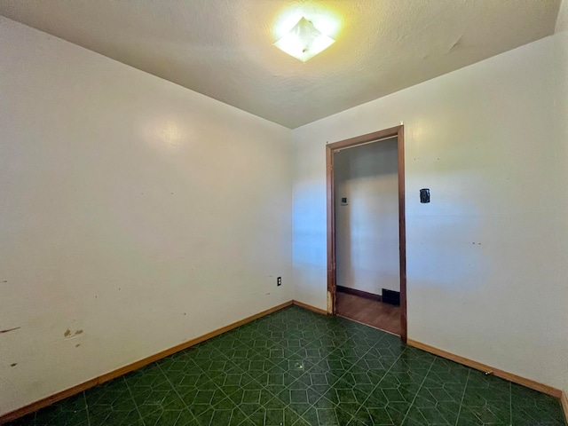 spare room featuring a textured ceiling