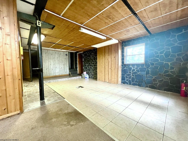 basement featuring wooden walls and wood ceiling