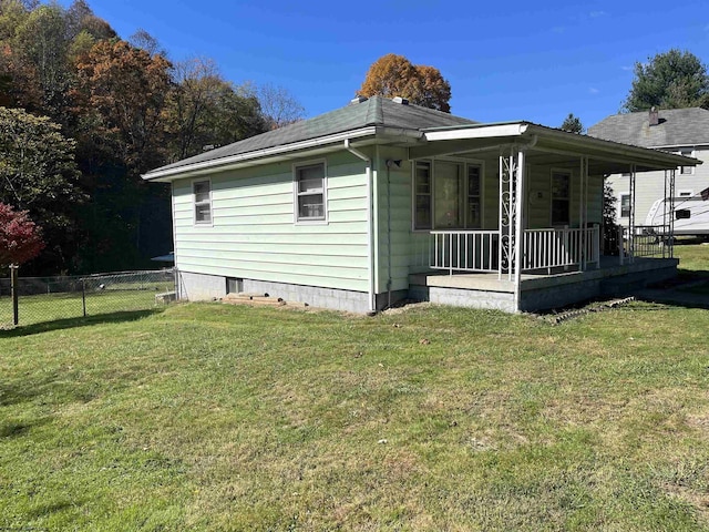 605 Warrior Fork Rd, Mannington, WV 26582 - view of side of home with covered porch, a yard, and fence