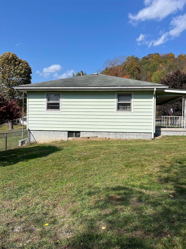 view of side of home with a lawn