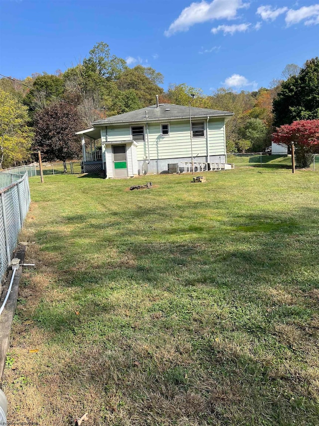 rear view of property featuring a yard