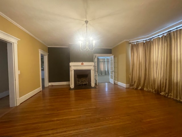 unfurnished living room with ornamental molding, hardwood / wood-style floors, and a notable chandelier