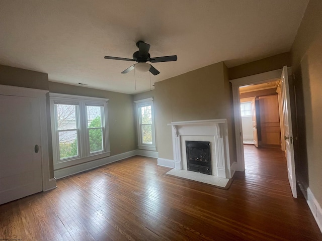 unfurnished living room featuring wood-type flooring and ceiling fan