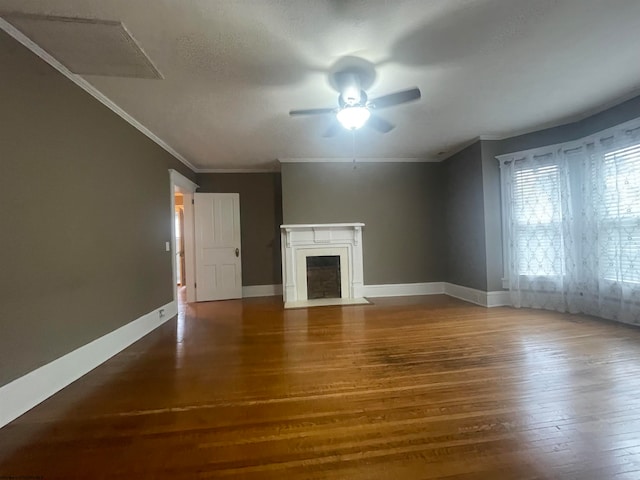 unfurnished living room with ornamental molding, a textured ceiling, dark hardwood / wood-style floors, and ceiling fan