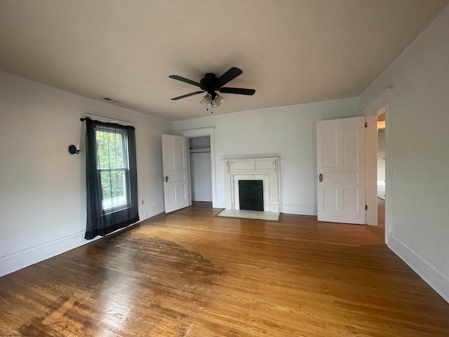 unfurnished living room with hardwood / wood-style flooring and ceiling fan