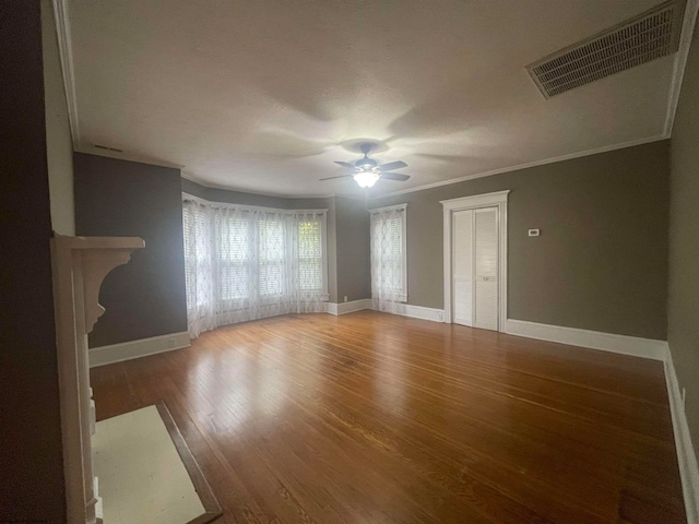 unfurnished living room with ornamental molding, hardwood / wood-style floors, and ceiling fan