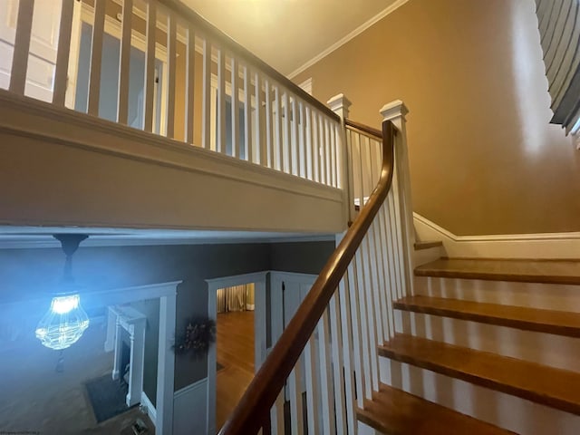 stairs featuring crown molding