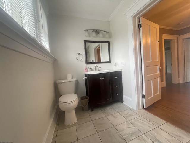 bathroom with vanity, crown molding, hardwood / wood-style flooring, and toilet