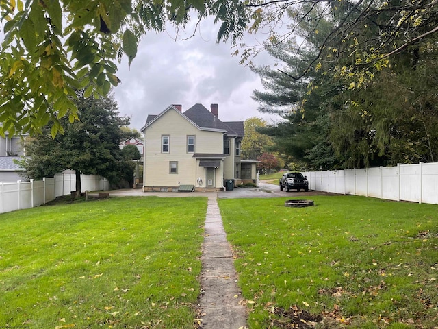 view of yard with an outdoor fire pit and a patio