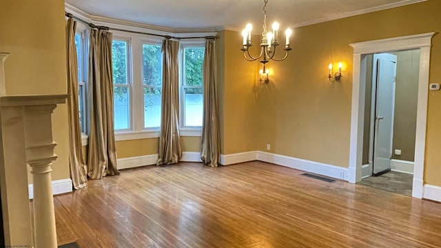 interior space with a notable chandelier, ornamental molding, and wood-type flooring