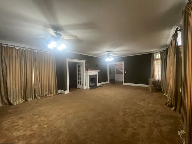 unfurnished living room featuring ornamental molding, carpet flooring, and ceiling fan