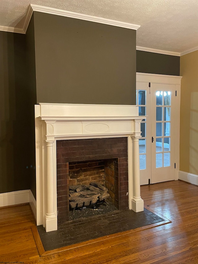 room details with hardwood / wood-style floors, crown molding, and a textured ceiling