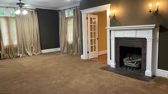 unfurnished living room with carpet, crown molding, a fireplace, and ceiling fan