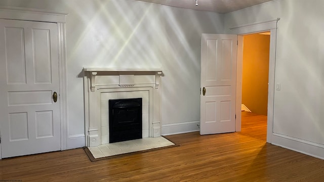 unfurnished living room featuring hardwood / wood-style floors and a fireplace