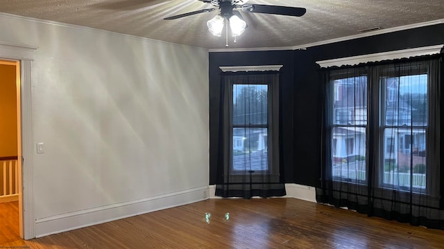 spare room with ceiling fan, ornamental molding, a textured ceiling, and hardwood / wood-style floors