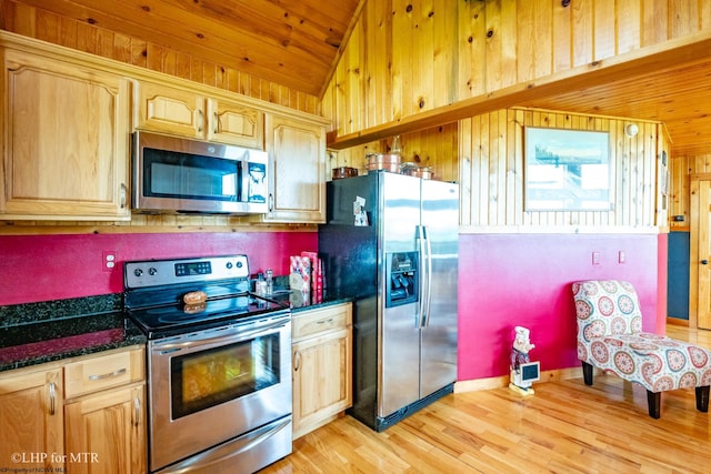 kitchen featuring wood ceiling, stainless steel appliances, dark stone countertops, light wood-type flooring, and vaulted ceiling