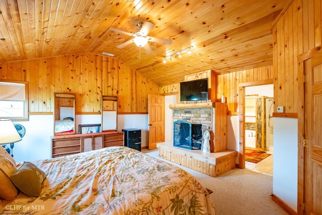 carpeted bedroom featuring lofted ceiling, a fireplace, wooden walls, and wooden ceiling