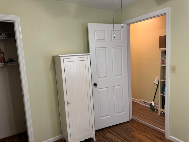 unfurnished bedroom featuring a closet, dark wood-type flooring, and a textured ceiling