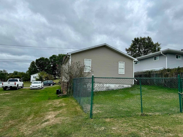 view of side of home with a lawn