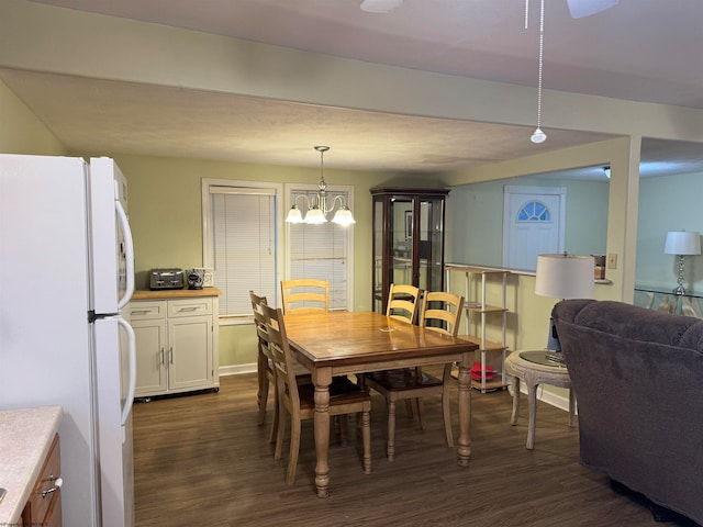 dining space featuring an inviting chandelier and dark wood-type flooring