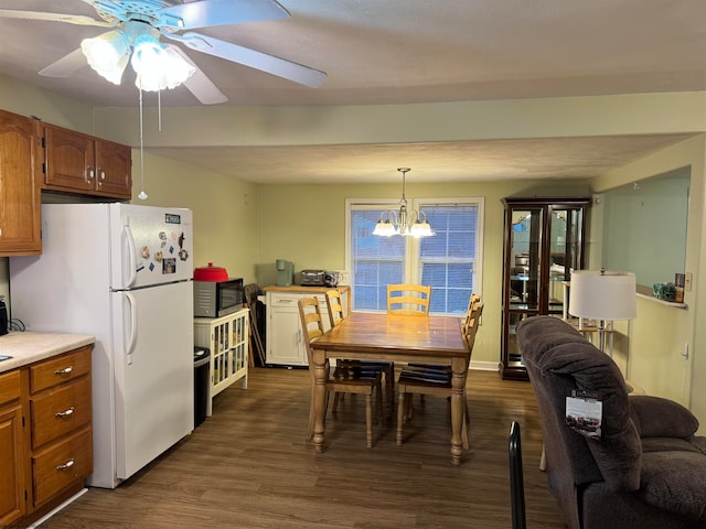 kitchen with ceiling fan with notable chandelier, white fridge, dark hardwood / wood-style flooring, and hanging light fixtures