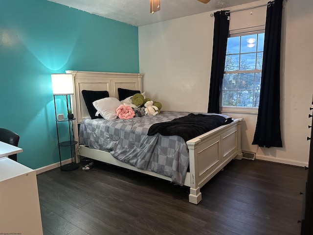 bedroom with ceiling fan and dark hardwood / wood-style flooring