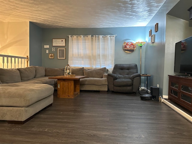 living room with a textured ceiling and dark hardwood / wood-style flooring