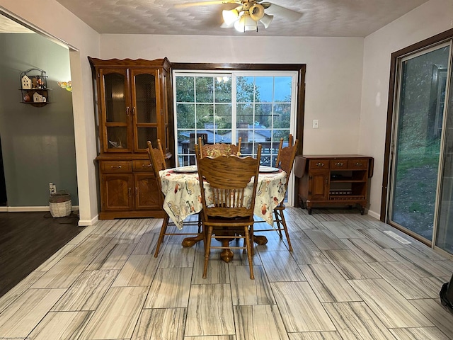 dining space with a textured ceiling, light hardwood / wood-style floors, and ceiling fan