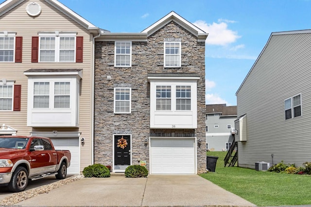 view of property featuring a front yard and a garage