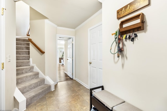 foyer entrance featuring crown molding