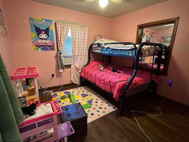 bedroom with ceiling fan, cooling unit, and dark hardwood / wood-style flooring