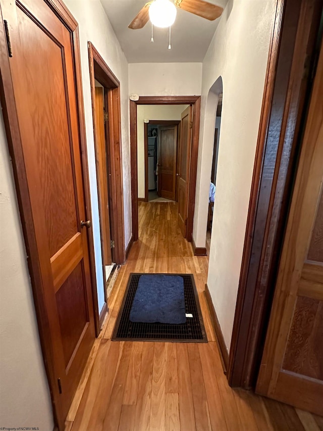 hallway with light hardwood / wood-style flooring