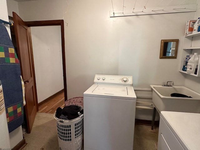 laundry room with light hardwood / wood-style floors, sink, and washing machine and clothes dryer