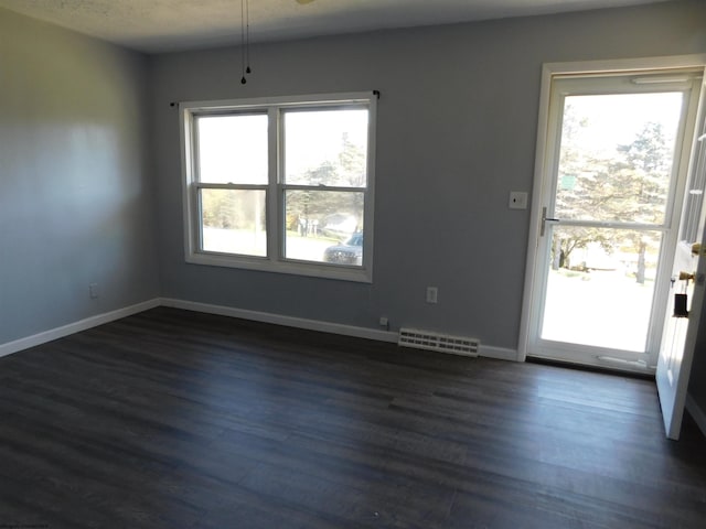 unfurnished dining area with dark wood-type flooring and ceiling fan