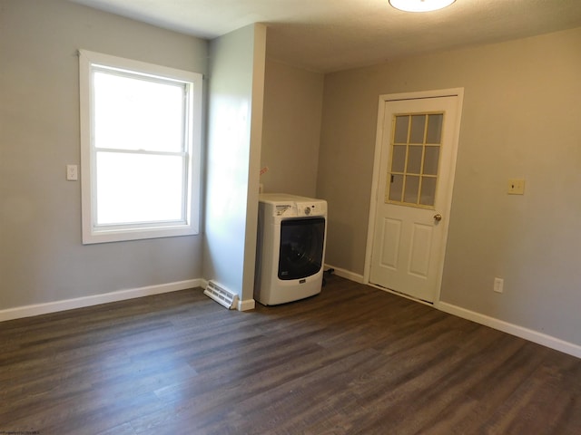 laundry area featuring plenty of natural light and dark hardwood / wood-style floors