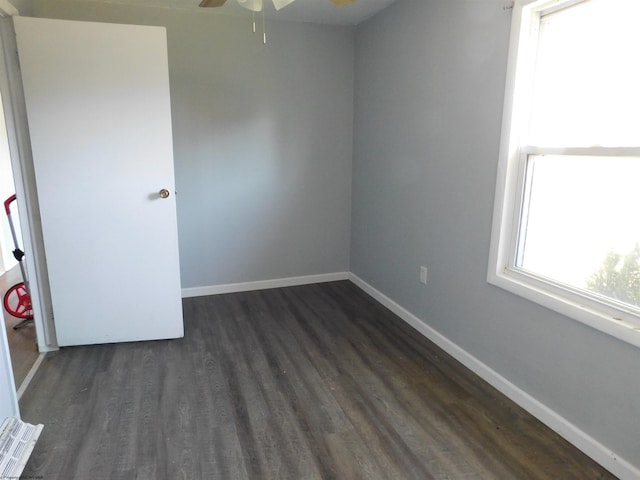 unfurnished room with ceiling fan and dark hardwood / wood-style flooring