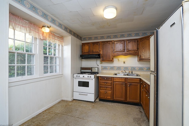 kitchen with white stove and sink