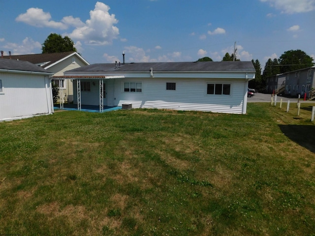 back of property featuring a yard and a patio area