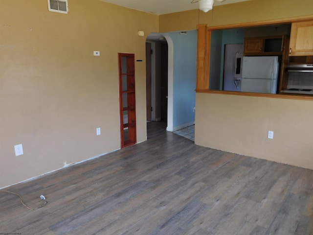 interior space with dark wood-type flooring and ceiling fan