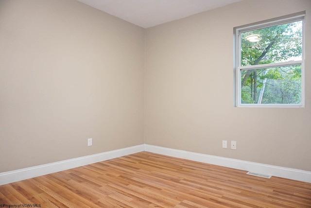 empty room with a healthy amount of sunlight and light wood-type flooring