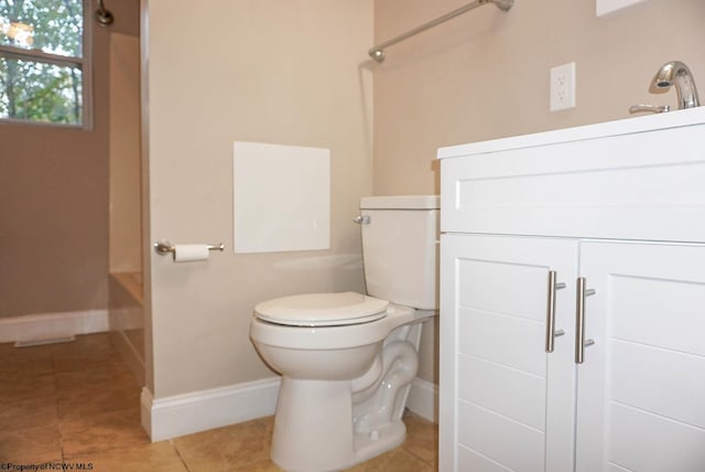 bathroom with vanity, toilet, and tile patterned floors