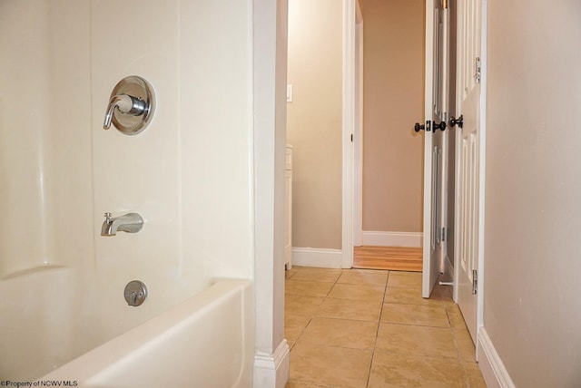 bathroom with bathing tub / shower combination and tile patterned flooring