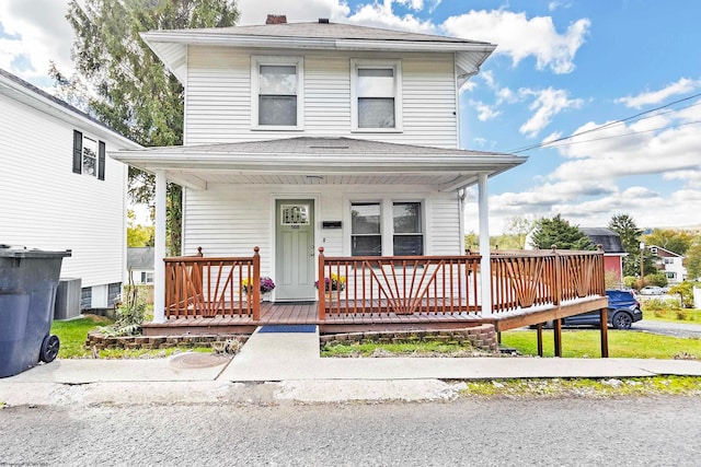 front of property featuring a porch and cooling unit