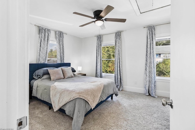 bedroom featuring carpet flooring, multiple windows, and ceiling fan